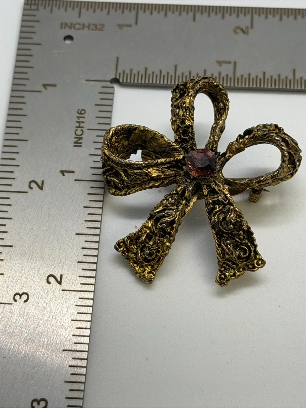 Gold-Tone Bow Brooch with Pink Center Stone